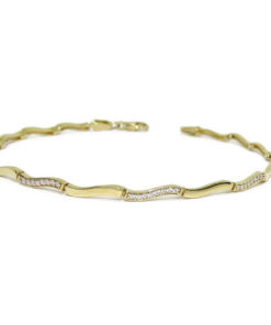 Pulsera de oro amarillo de 18 quilates para mujer con circonitas. Clásica y elegante.