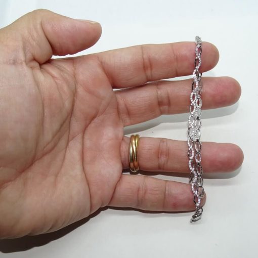 Pulsera semi-rígida de oro blanco de 18k con 15 infinitos y circonitas. - Imagen 2