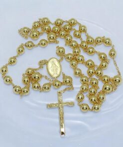 Rosario de oro amarillo 18 quilates con 60 cm de largo, cruz y medalla de la Virgen. 16 g de oro , 4 bolas de 6 mm y 50 de 5 mm. Certificado Never say Never. Tradición, calidad y fe en una joya eterna.